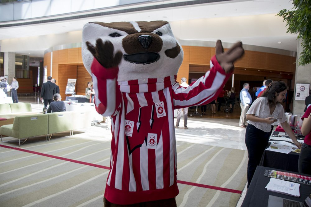 I_T_Academy's tweet photo. Last Friday, our ITA staff had the pleasure of showcasing the program at the @amfam and @UWMadison partnership event. We were so proud to be part of that historic moment!

@UWBuckyBadger looks great with our stickers on! https://t.co/1G7U8NHeq7