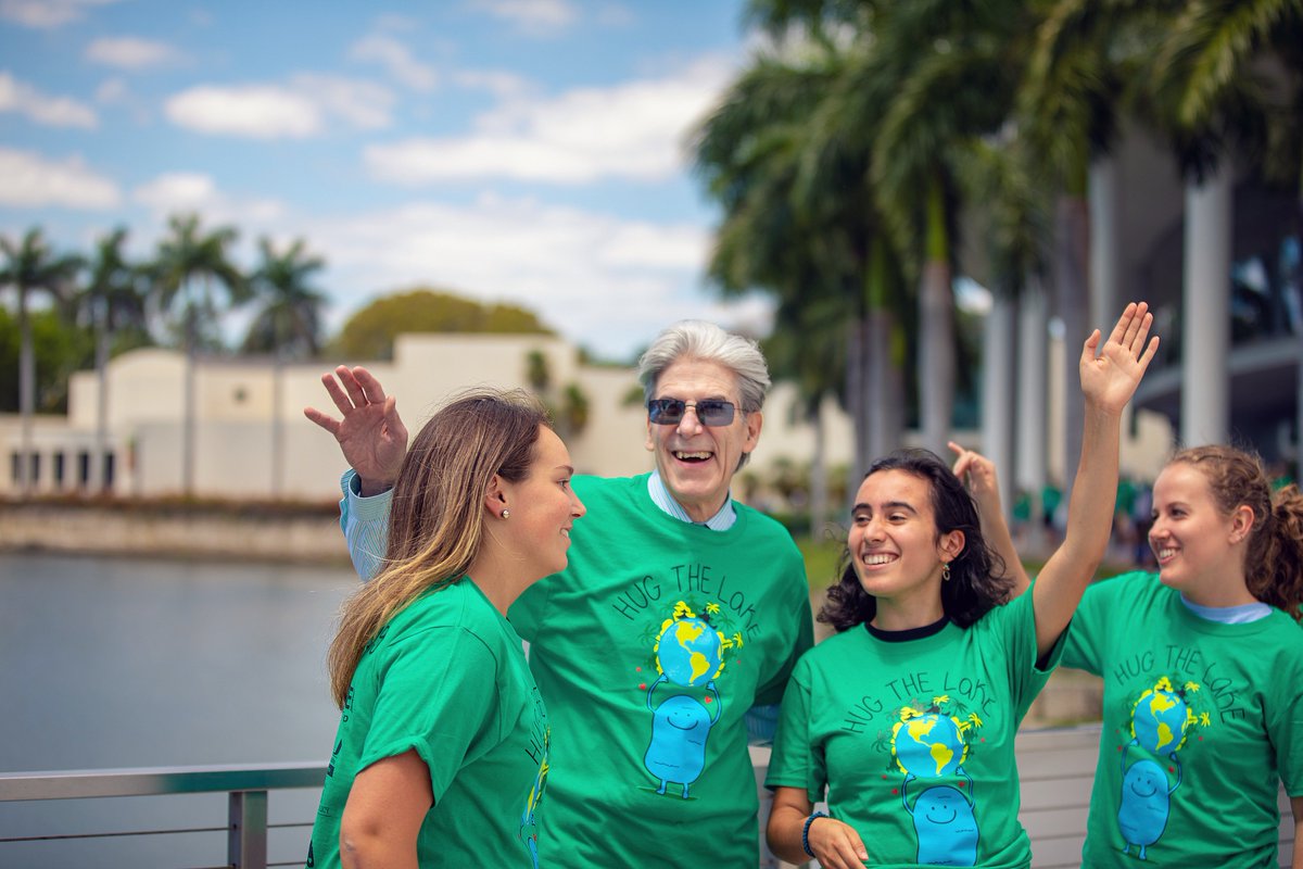 univmiami's tweet photo. Honoring #earthday, the #umiami community gathered around Lake Osceola to #HugTheLake, a 13-year old annual tradition to honor and recognize sustainable and eco-friendly practices at #theU. https://t.co/loOpHWK8si
