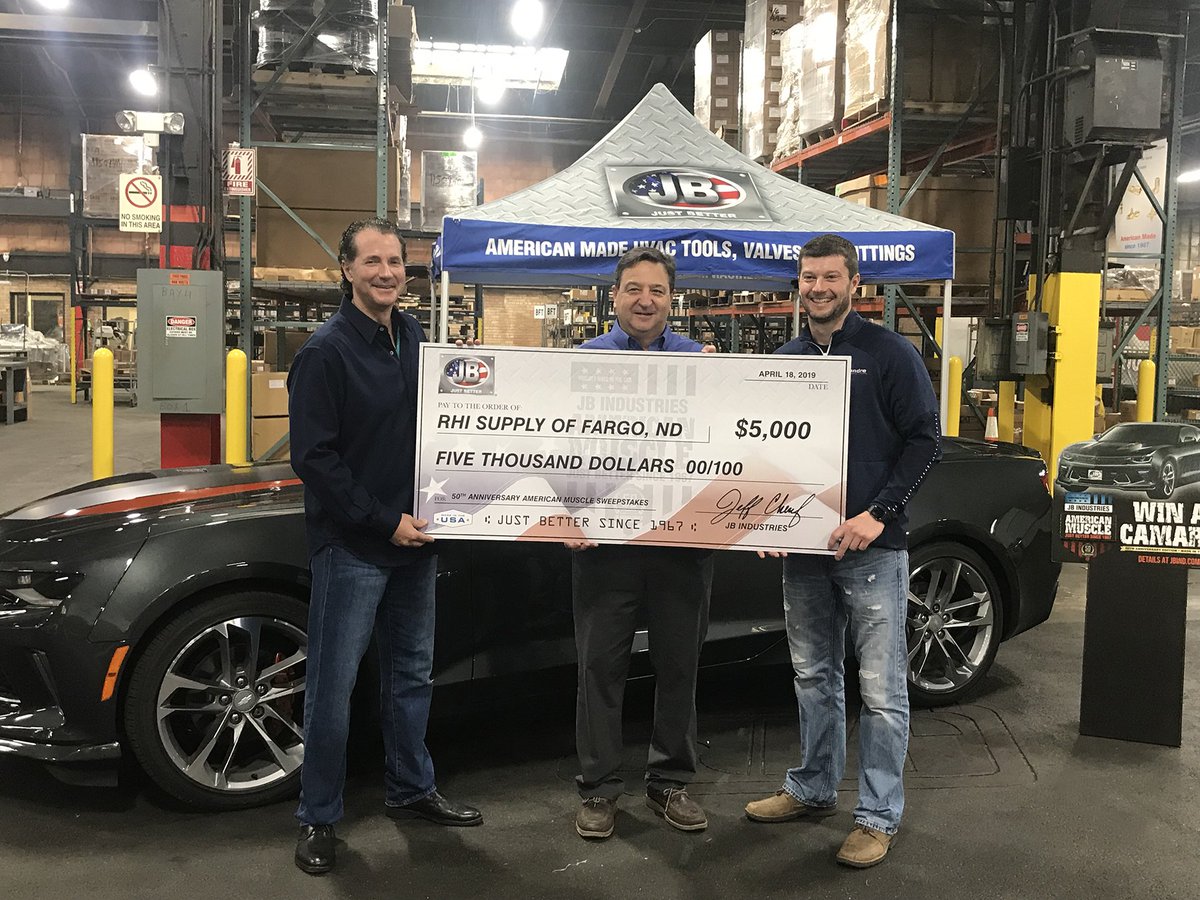 Chris Daly of RHI Supply in Fargo, ND receives award check for location of winning purchase to Travis Dahlin in the JB American Muscle Sweepstakes