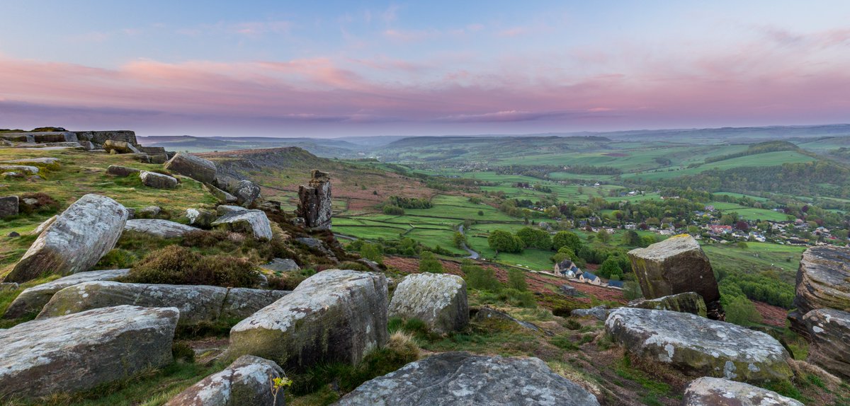 A panorama looking out across from the top of Curbar Edge across the fields past Baslow Edge