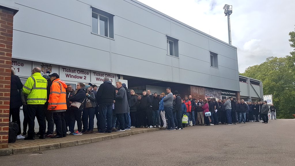 StevenageFC's tweet photo. It's busy outside the Ticket Office ahead of 2019/20 Season Tickets going ON SALE from 10am today. 🚨

The first 99 buying for the North Stand will cost just £99. 😁

#StevenageFC #WeAreStevenage https://t.co/AXUIxE9qyR
