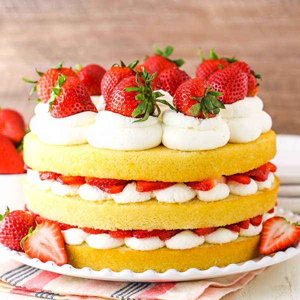 Strawberry Shortcake Cake! #sponsored An easy twist on the classic dessert with layers of moist vanilla cake made with @ChallengeButter, juicy strawberries and fluffy whipped cream! Perfect for summer BBQs and birthdays! #cake #recipe #strawberries lifeloveandsugar.com/strawberry-sho…