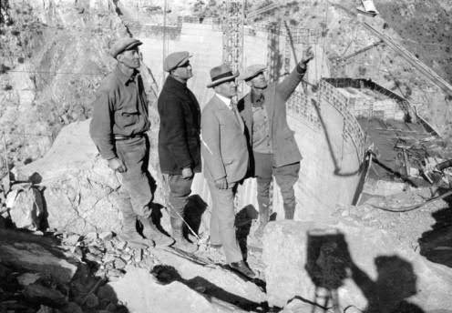 old photo of four men overseeing construction at pacoima dam