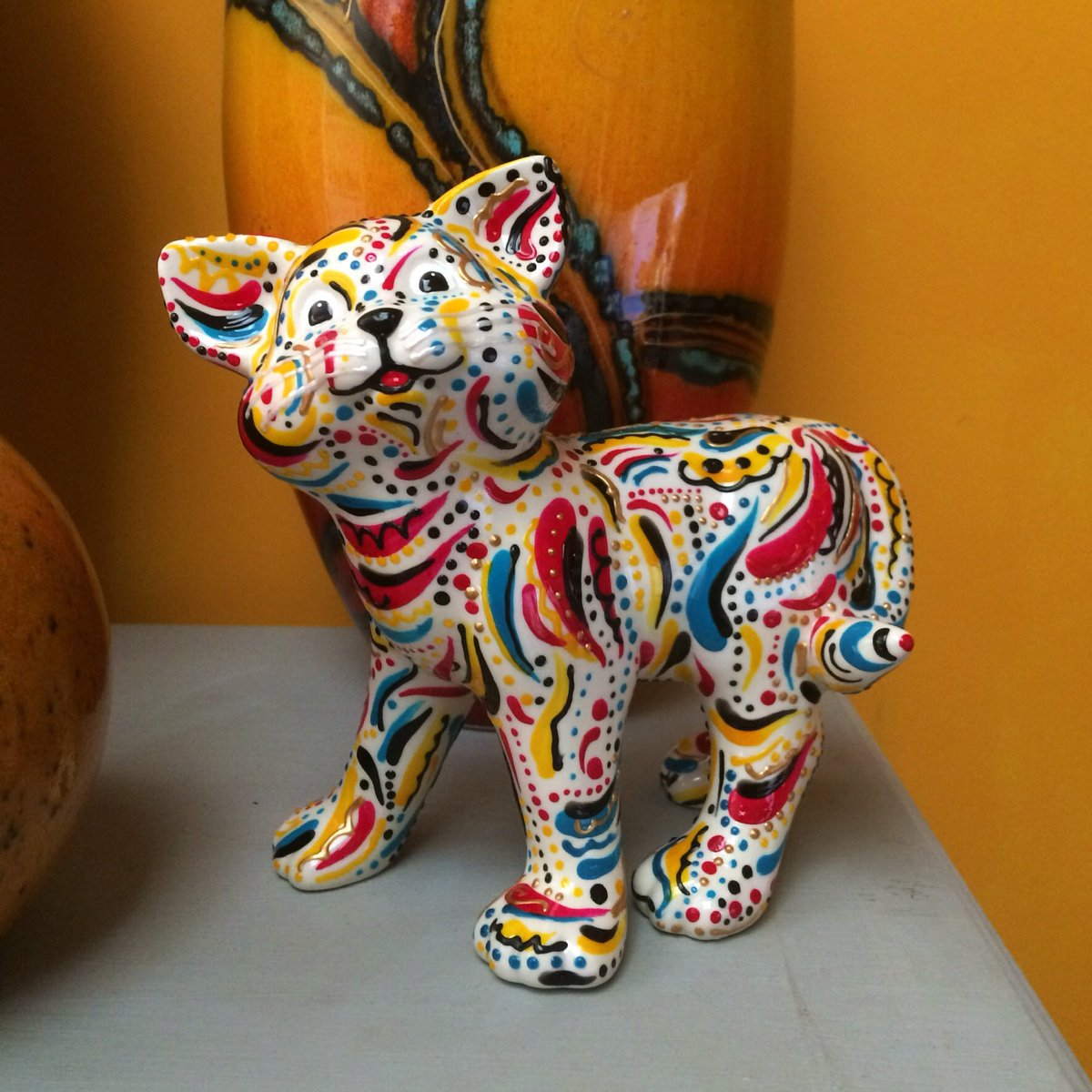 Hazceramics's tweet photo. My colourful cat needs a home. Painted in my Whirlpool design in ruby red, aqua blue, yellow and black/gold highlights. Available on Etsy priced at £15.99 with free uk shipping. https://t.co/ErtBfo8ayY #madeinukhour #creativebizhour #norwichhour #ukcraft https://t.co/v4NQ2qbigh