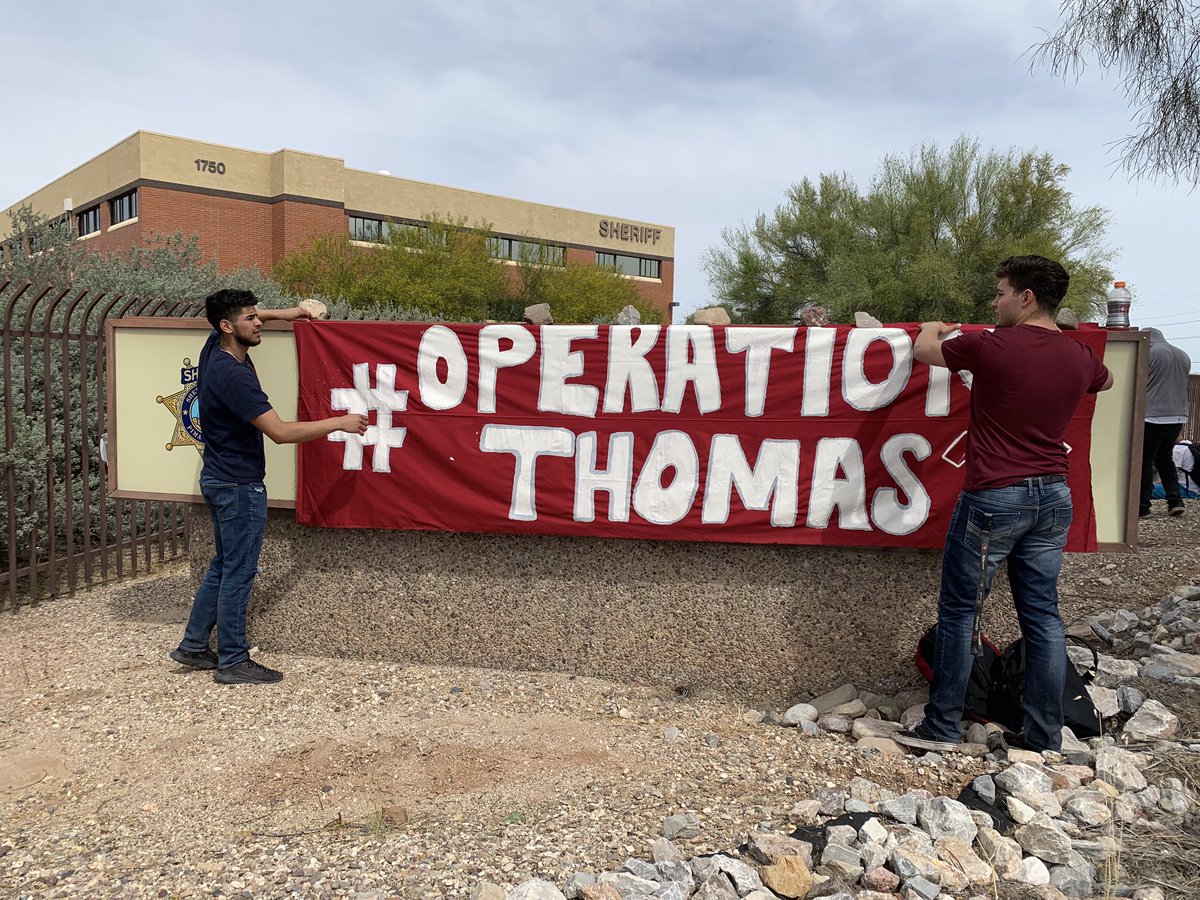 RafaelCarranza's tweet photo. Two students draped an #OperationThomas banner over the Pima Co. Sheriff’s Dept sign, they’ll be holding a press conference shortly to demand his release and end of cooperation between local law enforcement and Border Patrol. https://t.co/7GaGWiEy4q