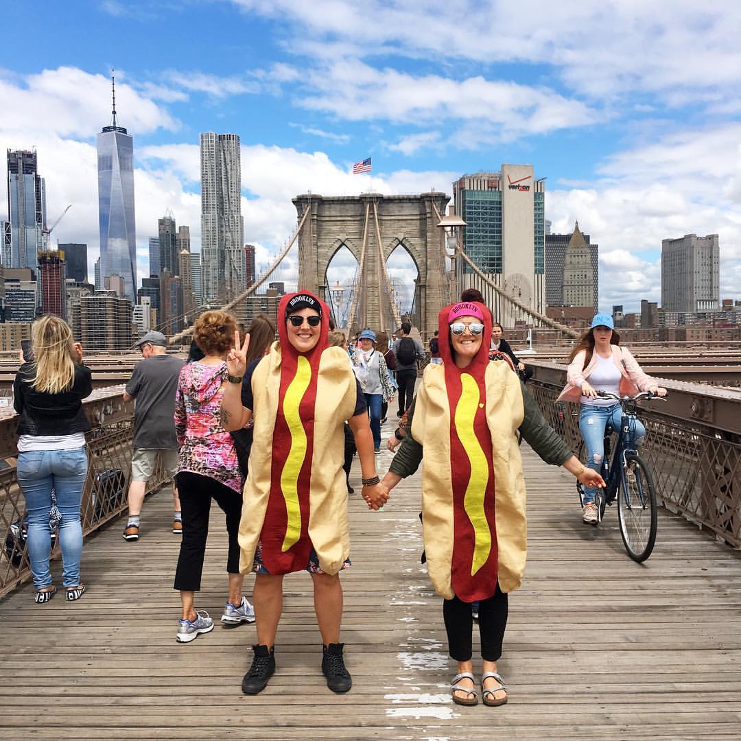 leahgregg's tweet photo. Whenever we travel, my awesome wife and I take photos in hotdog costumes and send them to my Grandma to make her smile. Sometimes our wee fur baby #misocorgi joins in on the fun. Here's a few to make you smile too! #hotdogswerehere https://t.co/7O02Mq398L