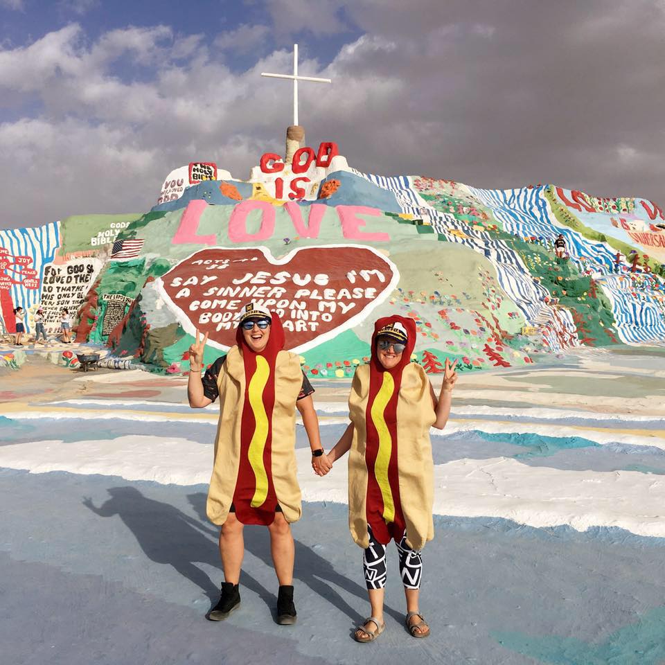 leahgregg's tweet photo. Whenever we travel, my awesome wife and I take photos in hotdog costumes and send them to my Grandma to make her smile. Sometimes our wee fur baby #misocorgi joins in on the fun. Here's a few to make you smile too! #hotdogswerehere https://t.co/7O02Mq398L
