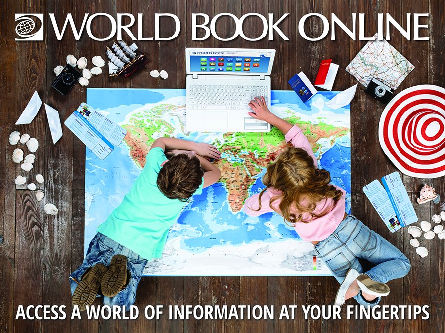 two children looking at a map of the world spread out on the floor