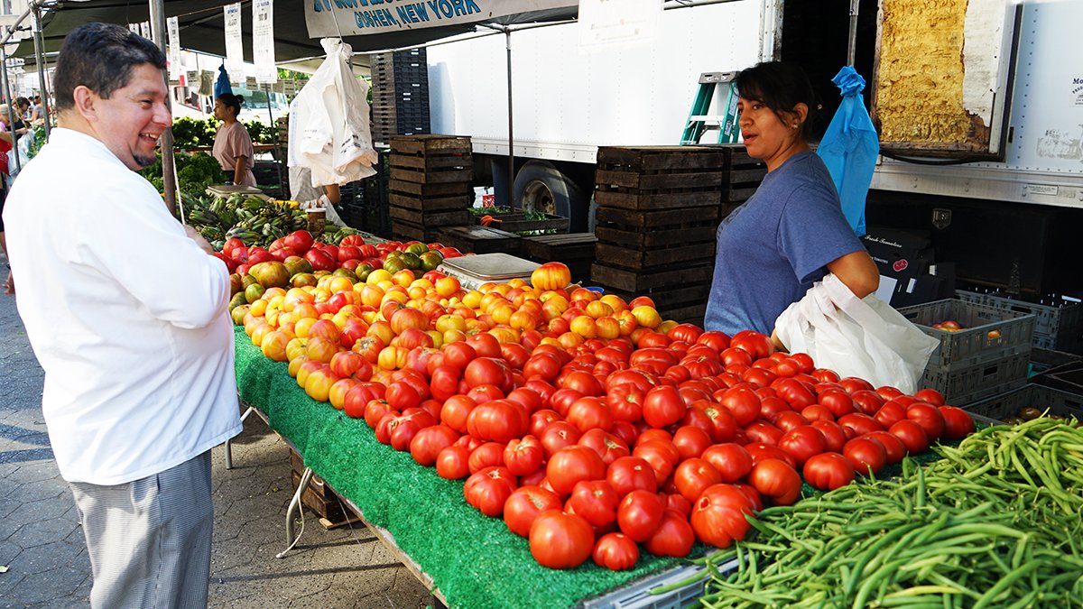 Farmer's market stand with various vegetables.