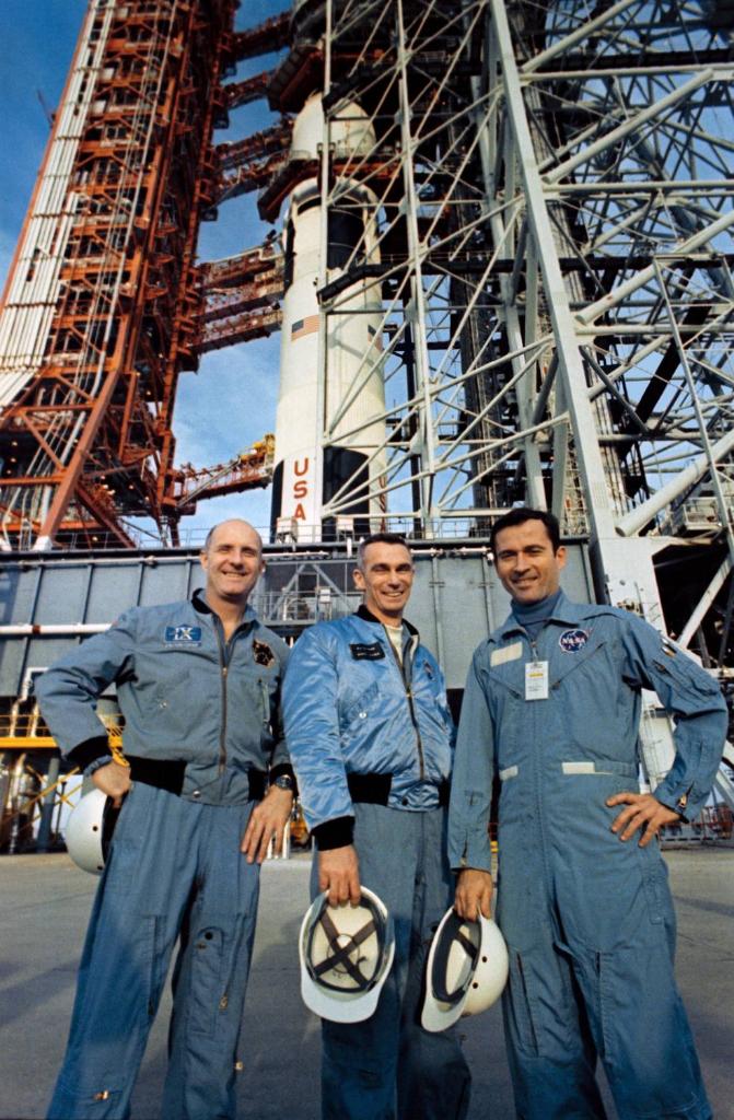 Apollo 10 astronauts (left to right) Stafford, Cernan, and Young stand in front of their Saturn V rocket at Launch Pad 39B.