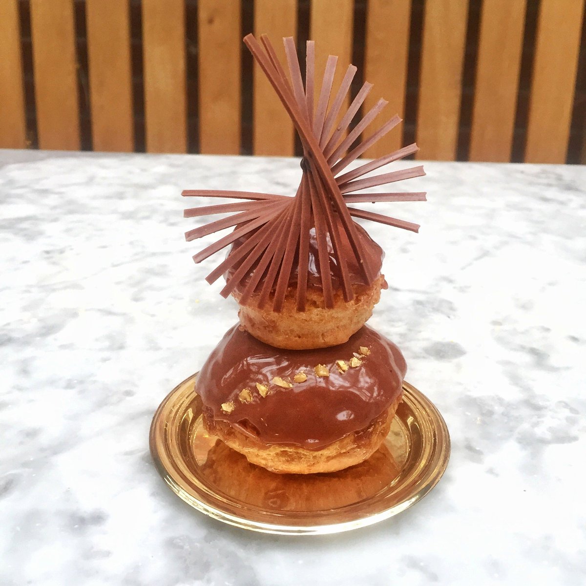 A closer look at our Coconut Hazelnut Religieuse, an elegant double-decker cream puff filled with hazelnut pastry cream and coconut ganache, and topped with a spiral of milk chocolate pieces each hand-placed on one by one. Available daily at the bakery. #DABLondon