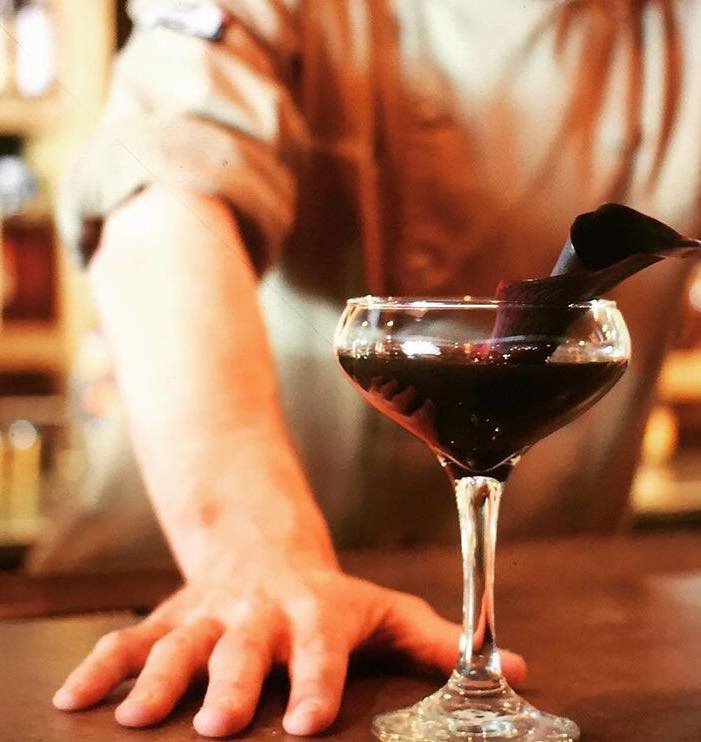 We call this elegant and mysterious drink Lust (made with barrel-rested gin, Fernet Branca, Rhubarb &amp; Cardamom Shrub with activated charcoal and Black Canter Lily). Now available on our Spring cocktail menu. 📷: <a href="/themillmag/">THE MILL MAGAZINE</a> #loftandcellar #cltdrinks