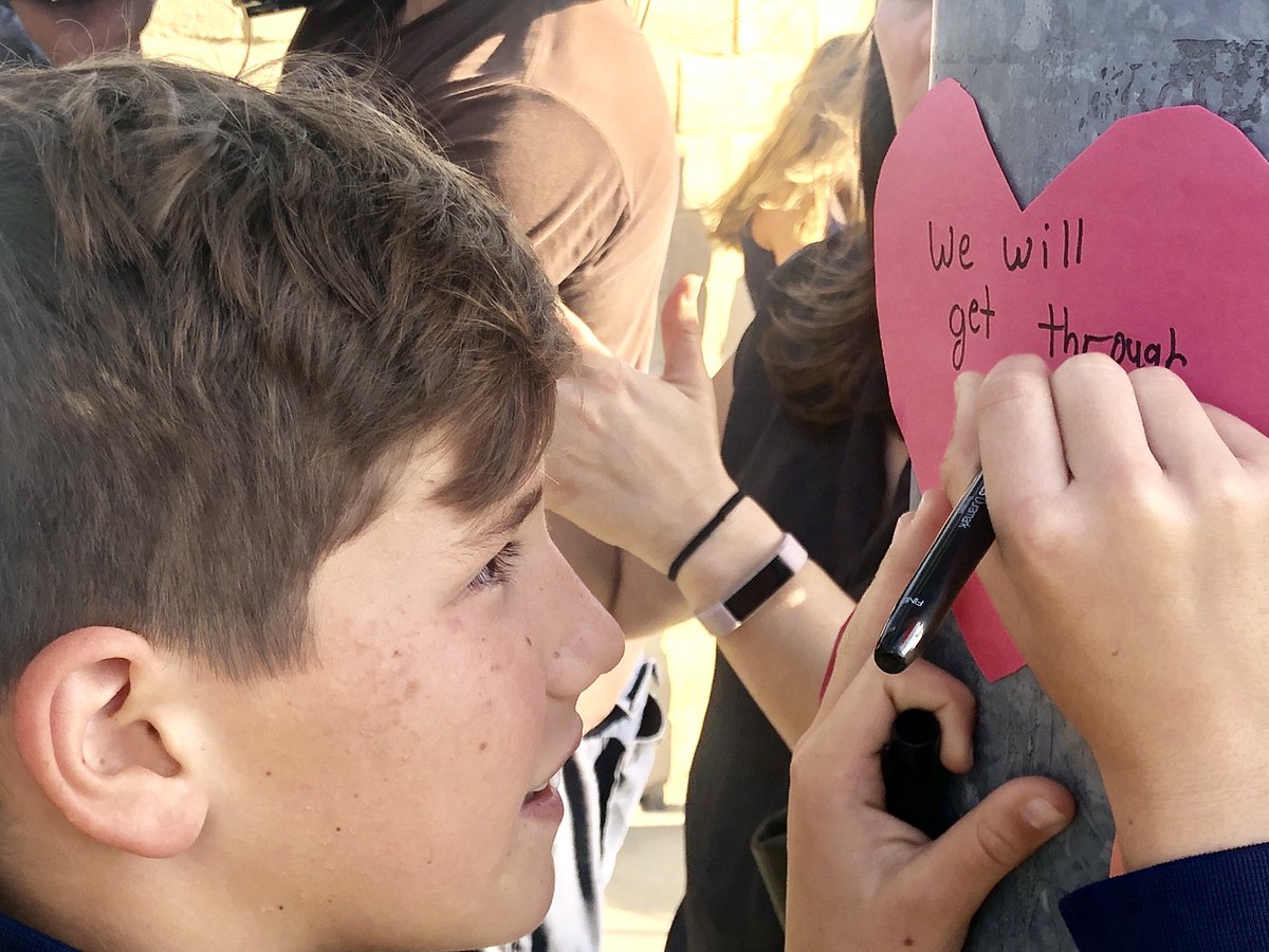 Alexander, (11) writes 'We will get through this' at #PowaySynagogue. We need all children to learn to stand together. #strongerthanhate