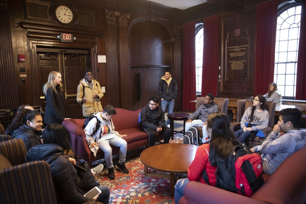 Students sit on couches and chairs in one of the Harvard Houses. 