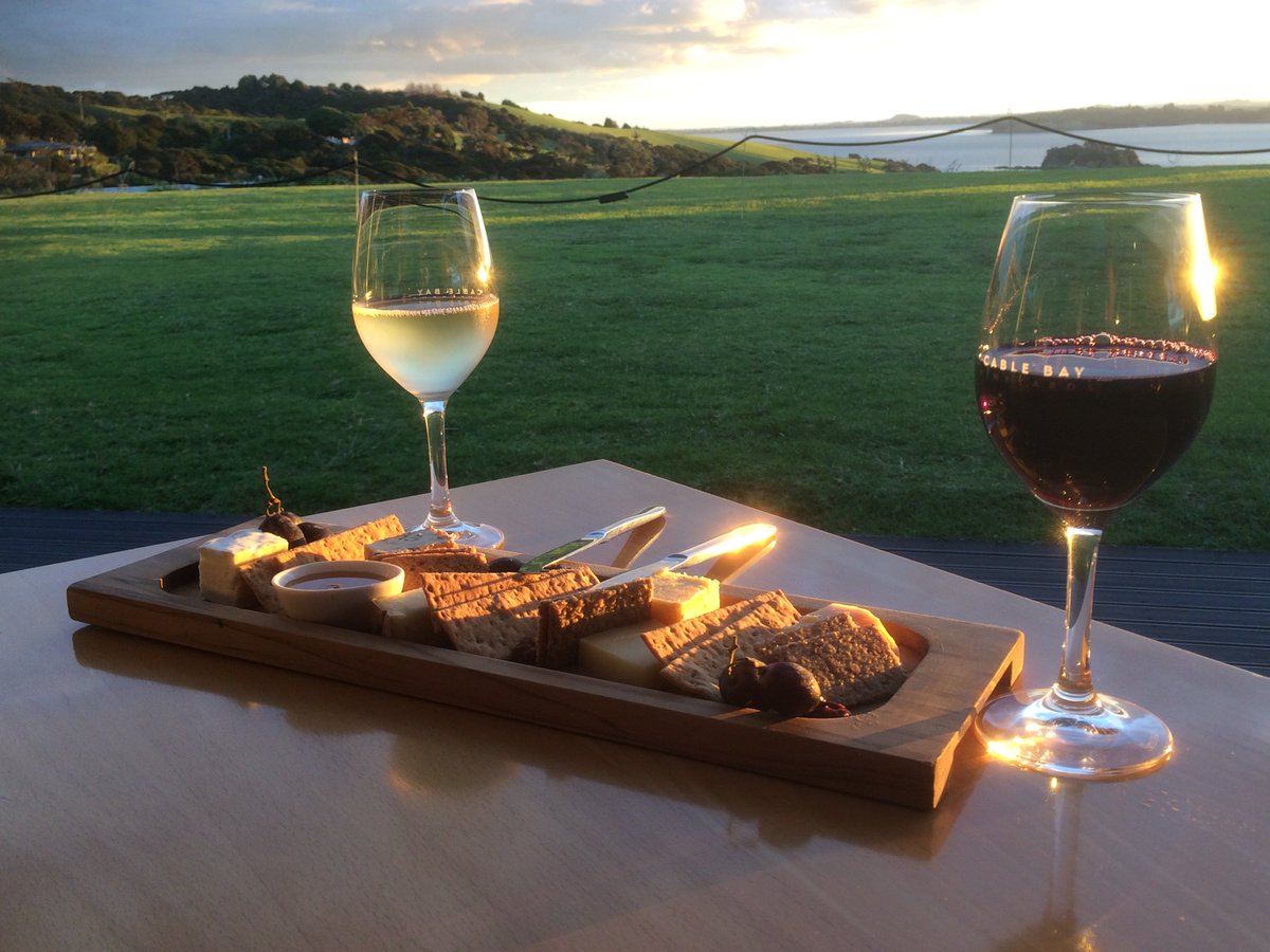 Cheese and wine at sunset overlooking the sea. Could there be a more perfect end to our day on Waiheke Island? #travel #NewZealand #Waiheke #daytrip