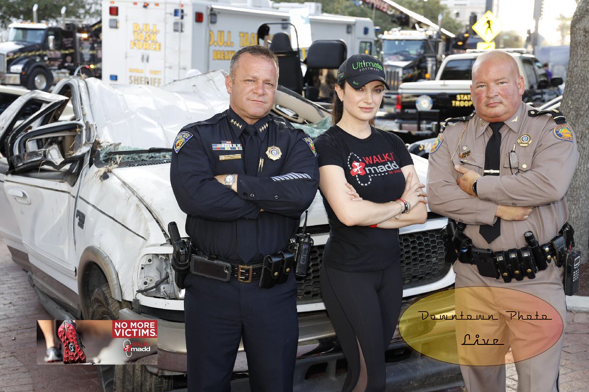 Chief Maglione posing for picture in front of crashed car
