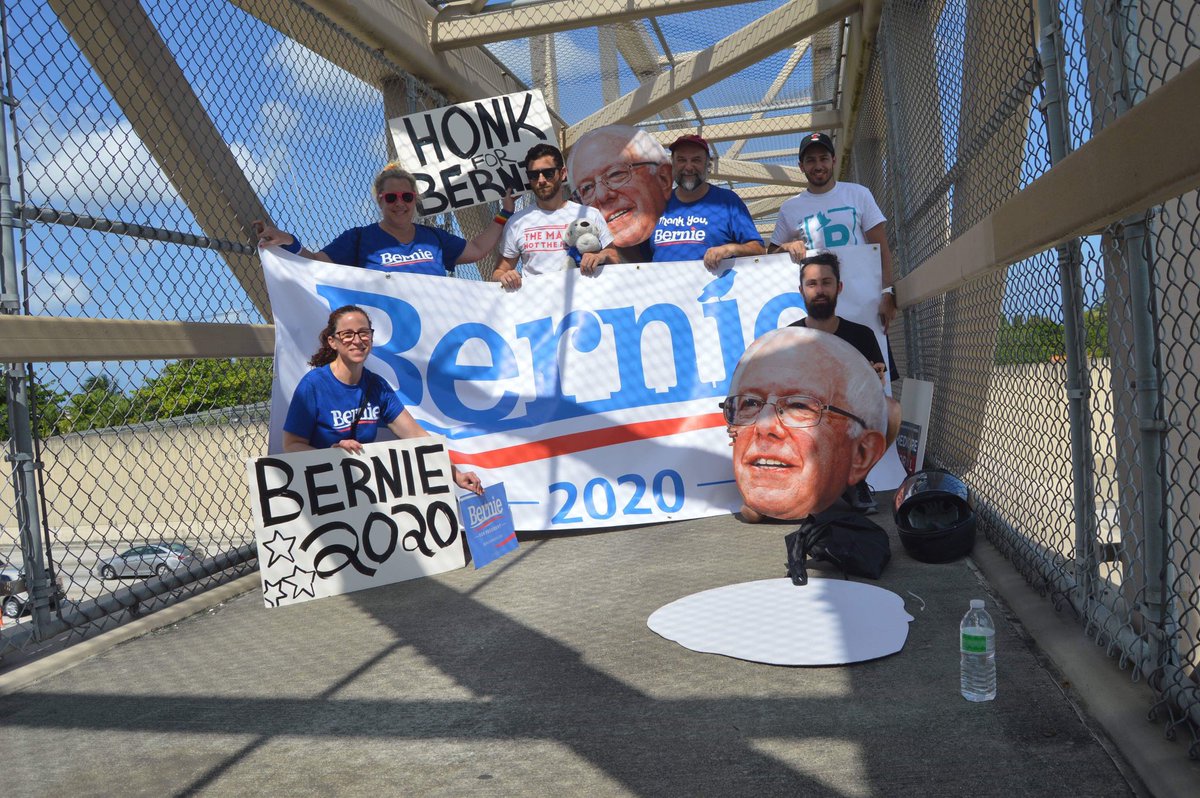 OurRev305's tweet photo. We had a BLAST at our Bernie Banner Drop (despite 84 degree temps). 🥵 All the honking kept us energized! #OurRev305 #OurRevolution #Bernie2020 #OrganizeForBernie #MiamiForBernie #BerningInMiami https://t.co/q992zFCuw1