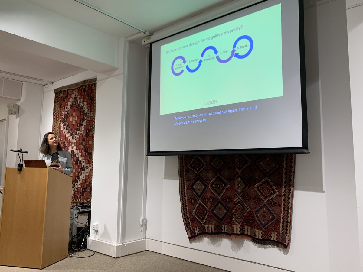 Christine Hemphill, Managing Director at Open Inclusion in front of a slide saying “so how do you design for cognitive diversity”