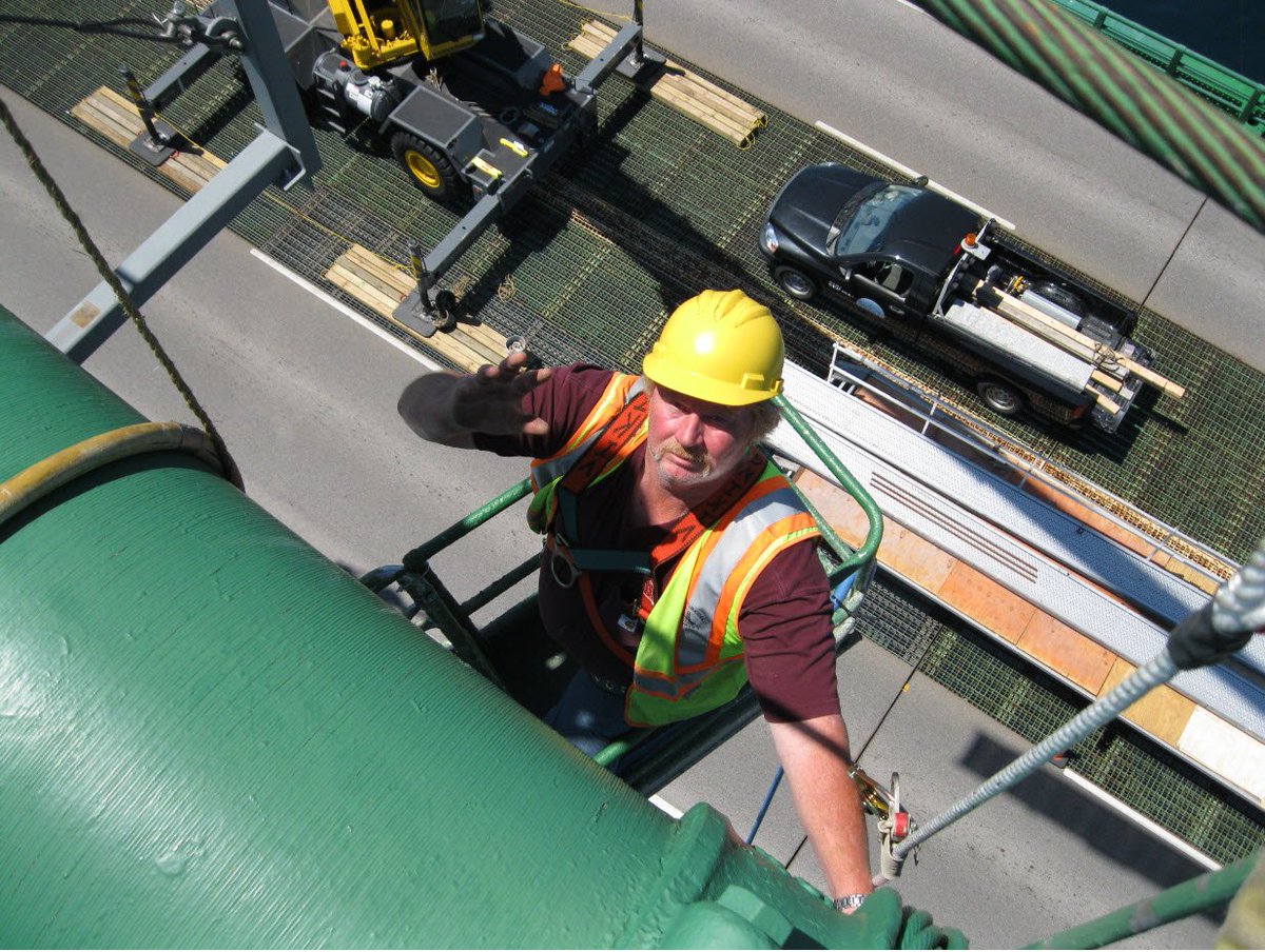 mackinacbridge's tweet photo. If you cross @MackinacBridge this summer, you may see our maintenance crew working on the cables, but we no longer send our crew up in a modified steel drum. They are lifted using a steel basket these days! It's safe to say that our maintenance has never been afraid of heights! https://t.co/d9xtA5iQFh