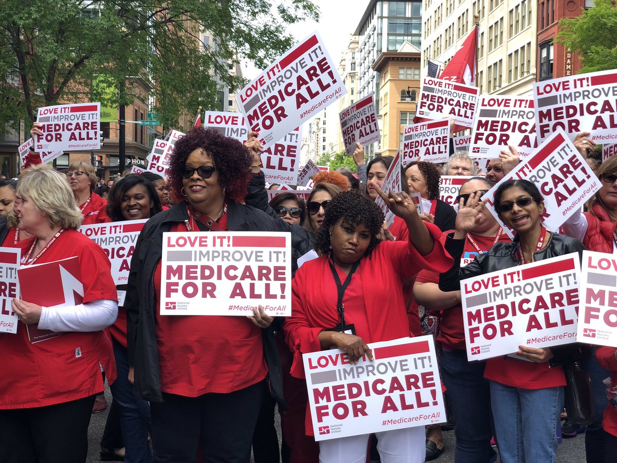 Photo of women holding Medicare for All signs.