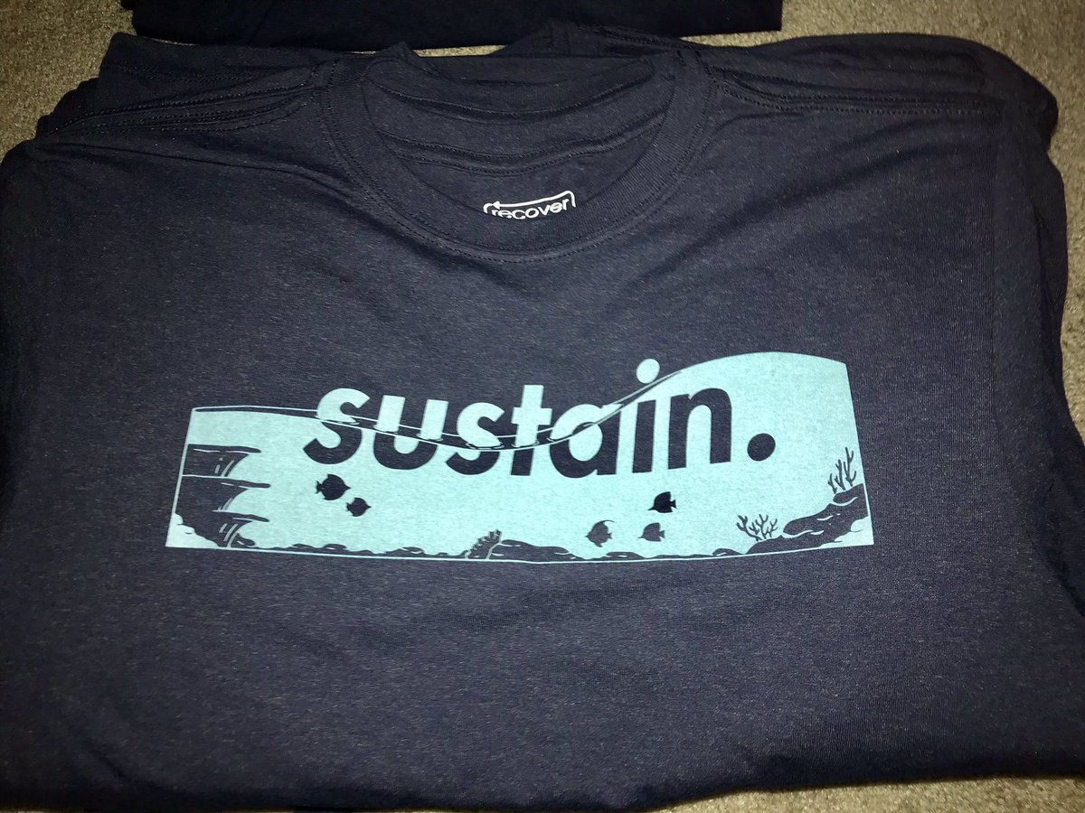 sustain_env's tweet photo. Ocean T-Shirts are in! Get yours quick before they run out (only 85 left).🐟🌊

Only recycled materials used, 25% of profits go to @OP_Society, @nolaNJDowns designed it, &amp; you’ll look good wearing it. #sustain.🐠 https://t.co/dp51YipTfq