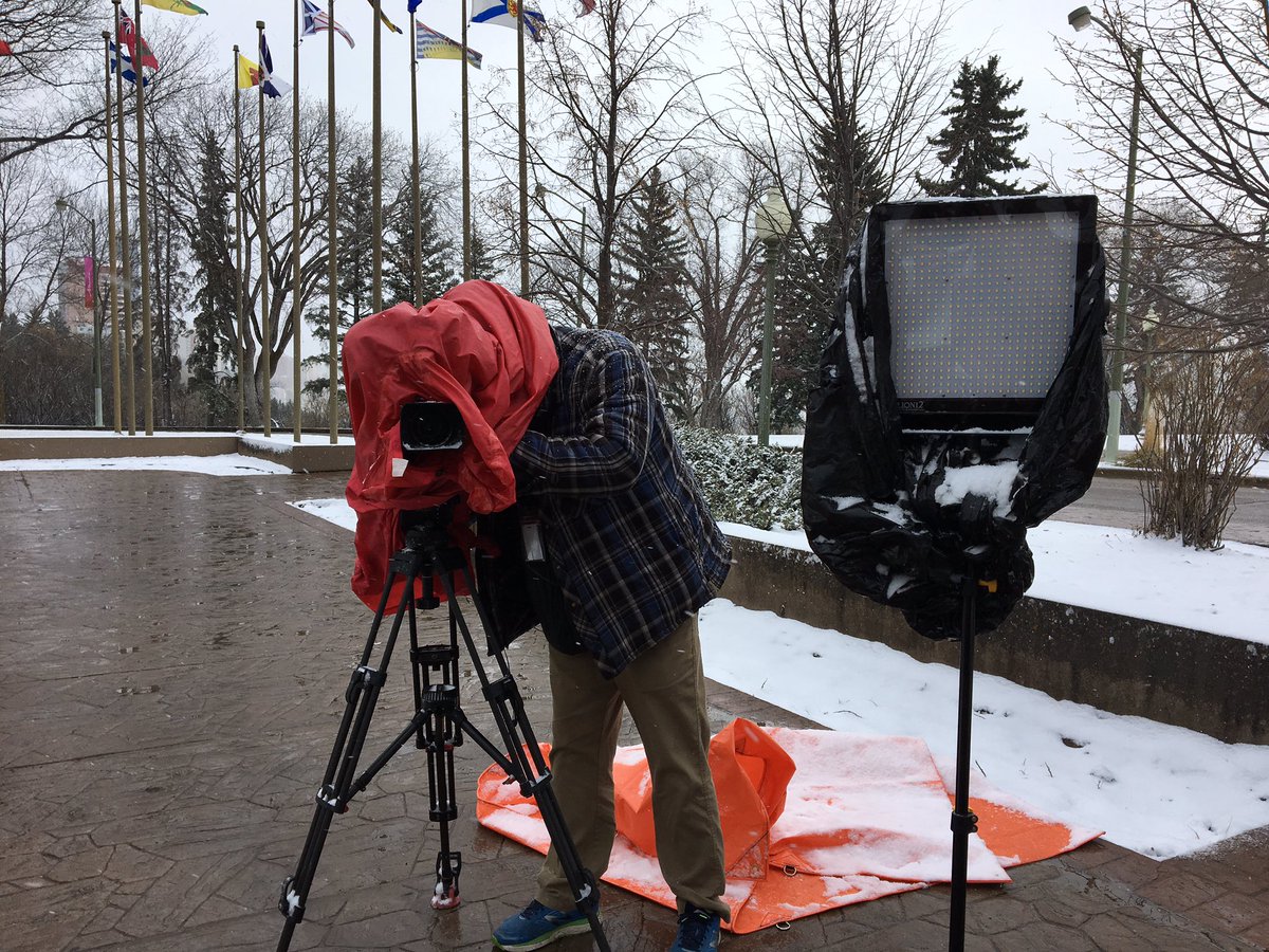 This is what you don’t see. <a href="/DaveCarels/">DaveCarels</a> doing all he can to keep his gear dry in this spring snow! <a href="/GlobalEdmonton/">Global Edmonton</a> #yegweather