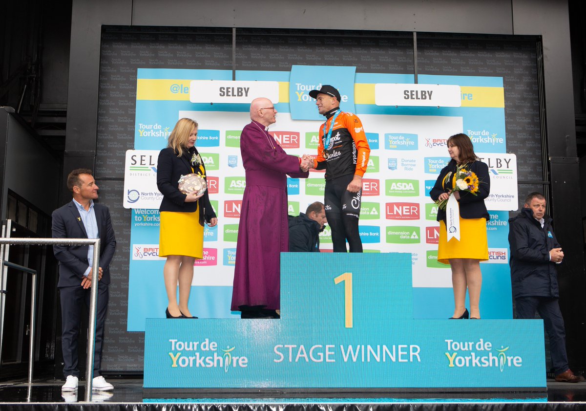 DioceseOfYork's tweet photo. #Selby played host to the first stage of the #TourdeYorkshire yesterday, with Bishop John Thomson handing out the prize! Congratulations to winner #JesperAsselman from #TeamRoompot, and thank you @SelbyDC for these wonderful photos. https://t.co/XHwrv8O1uu