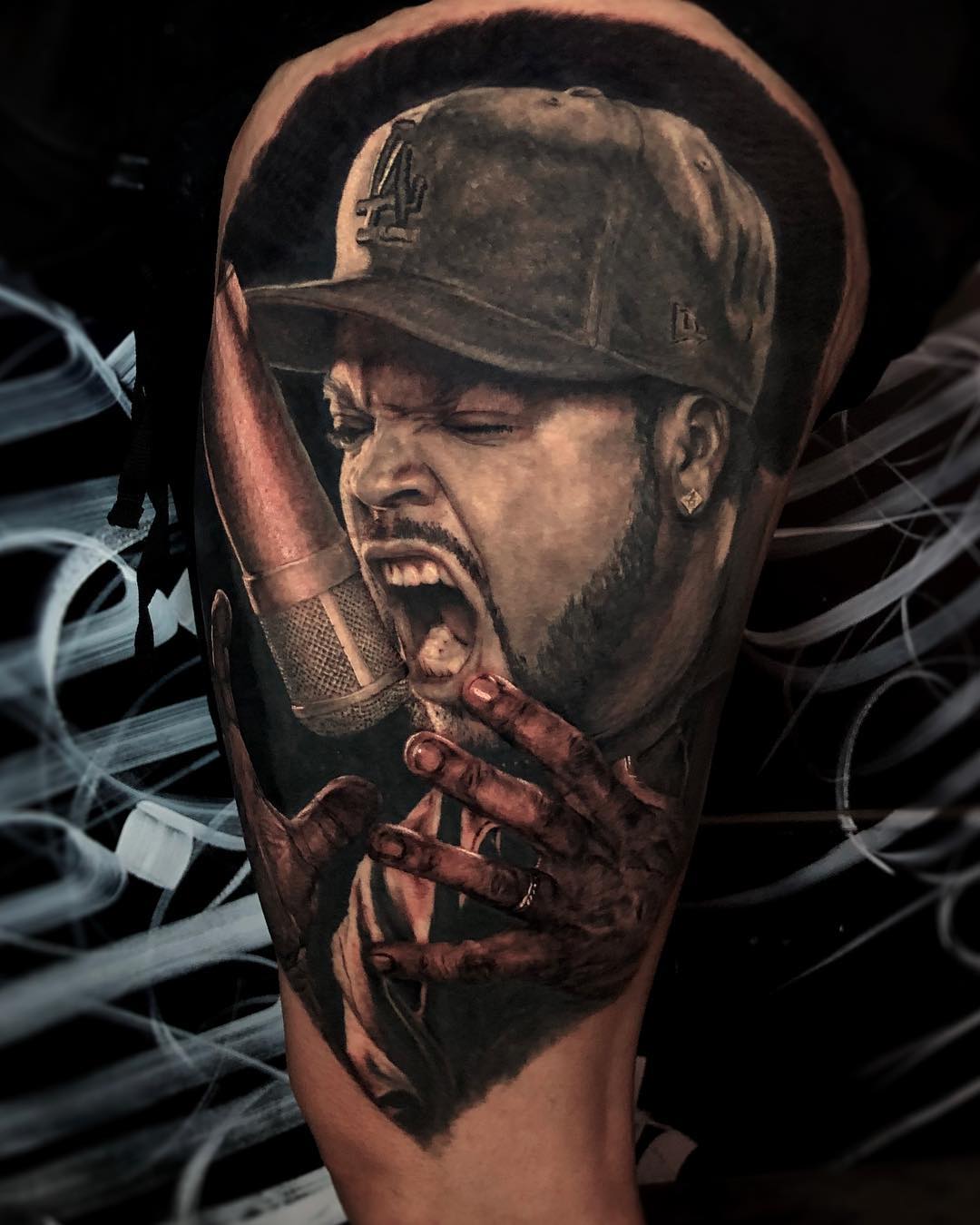 Black and grey Ice Cube portrait tattoo on the calf