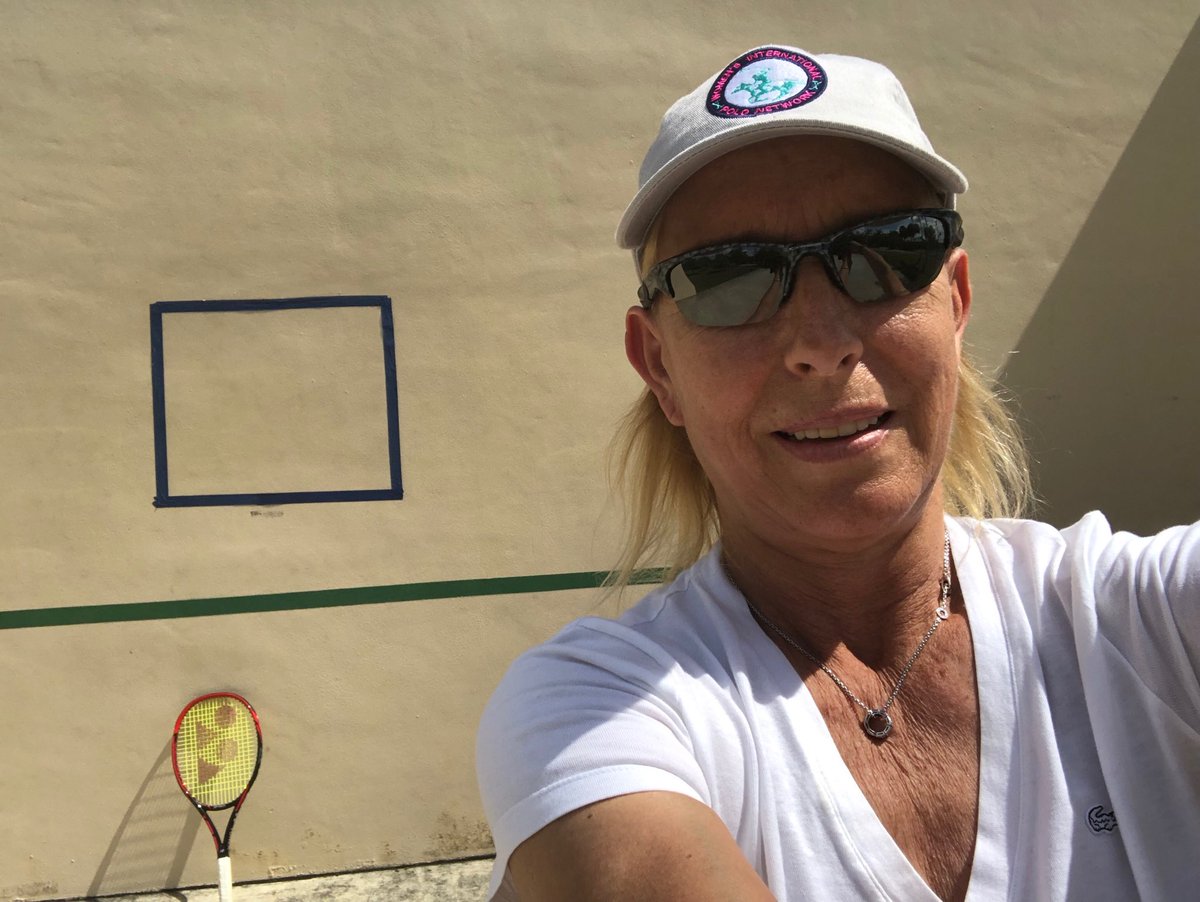 Martina's tweet photo. When you can’t find neither a partner nor a court , a wall will do the trick :) #goingbacktotheroots https://t.co/Mx4dBjF2MI