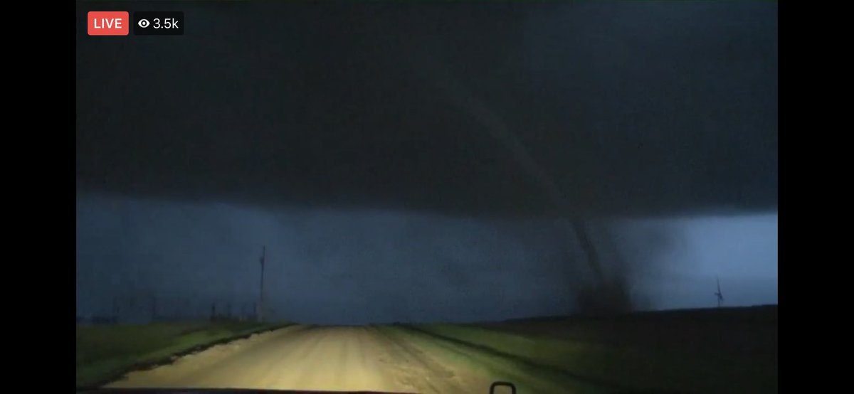 LaceySwope's tweet photo. Large long track tornado still on the ground headed toward Ford, Kansas. This thing has overturned semis, and hit homes! 9:17 PM. 

Val and Amy are tracking it. #okwx @NEWS9 @valcastor https://t.co/d2egHRT6Ke