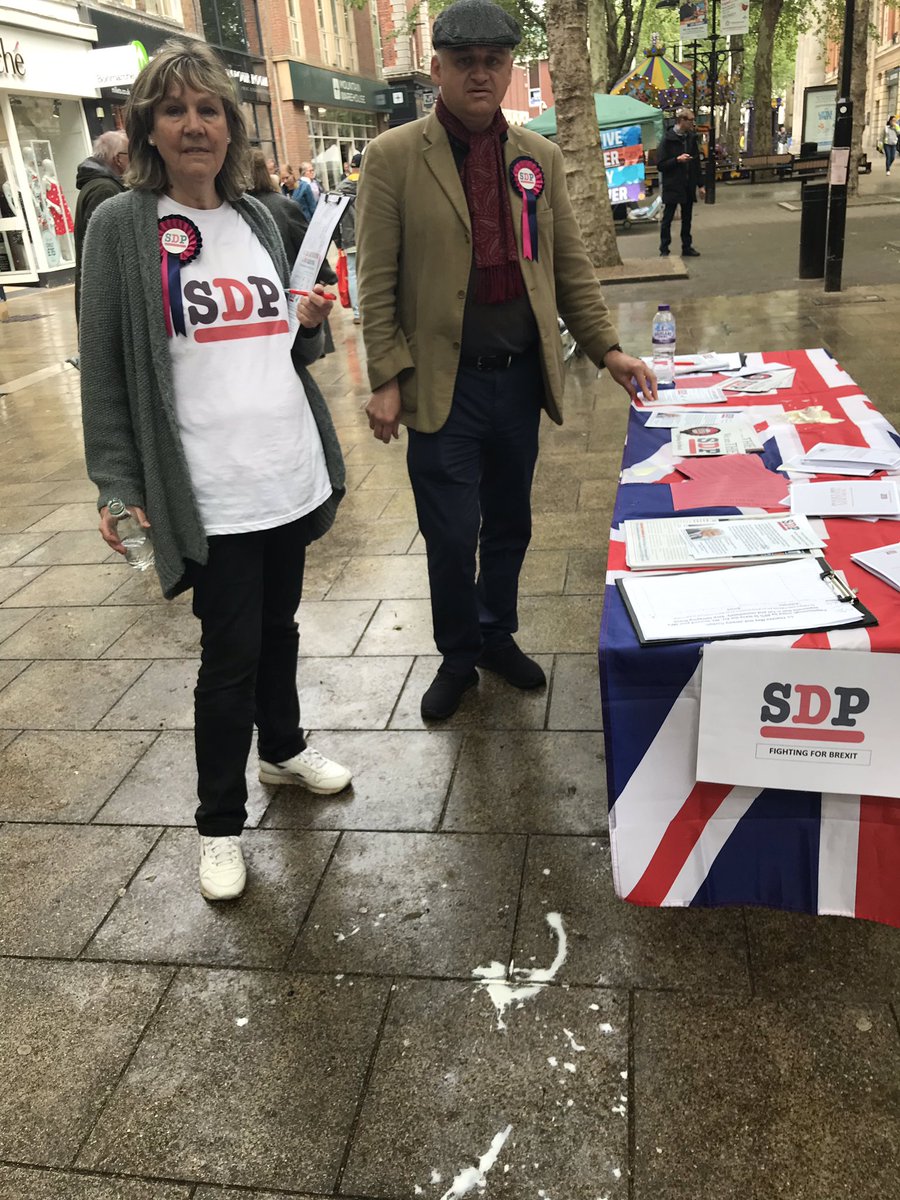 lisaduffy1968's tweet photo. SDP stall in Peterborough attacked whilst campaigning for Patrick O'Flynn SDP MEP candidate for Peterborough by-election. Milkshake thrown over the table and water stolen then thrown at SDP campaigner Mary Herdman https://t.co/EmKmh2WdD9