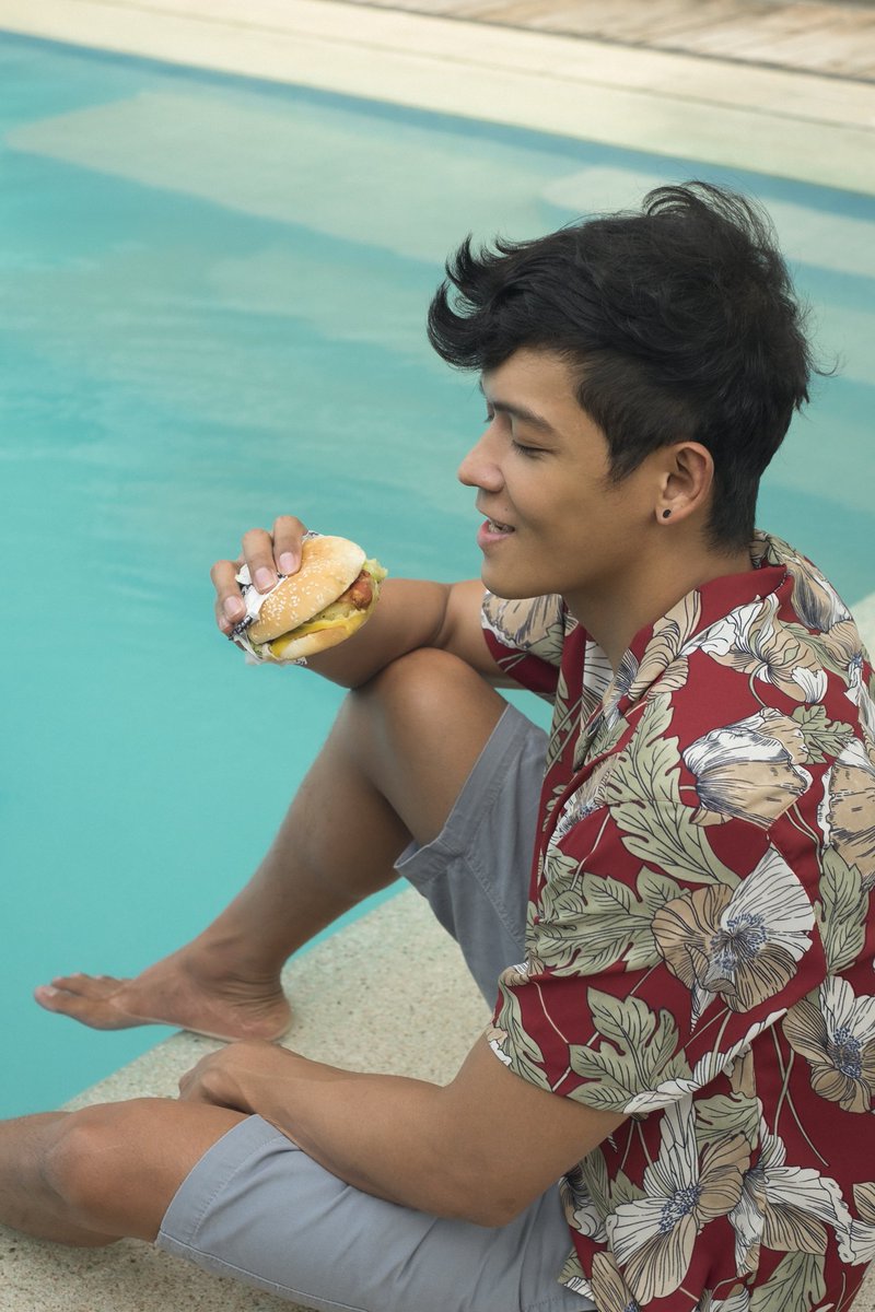 Taking a break from work with a quick dip and enjoying my <a href="/Jollibee/">Jollibee</a> #AmazingAlohaYumBurger ! Every bite takes me to my own summer getaway! Sweet and savory, nothing beats that! 😋😋😋
