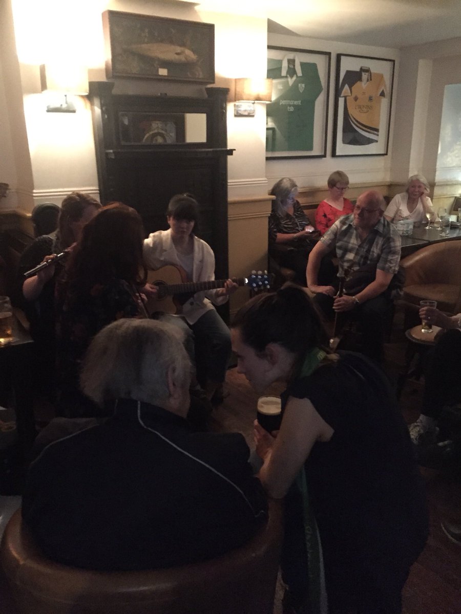 OisinCoghlan's tweet photo. Who needs the Eurovision. Pete St John looks on as Tri lead the session in Teach na N’ól in Louisburgh after the @AfriPeace #FamineWalk. https://t.co/SbeeDDUYqc