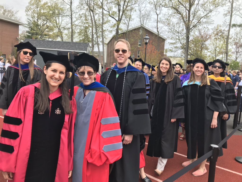 Merrimack's tweet photo. As our faculty walk into the stadium you may notice their academic regalia are different. From each cap, gown & hood, it’s possible to distinguish the institution from which the wearer graduated, the field of learning in which the degree was earned & the degree level. #MackGrad https://t.co/SN0Ps6GiOR