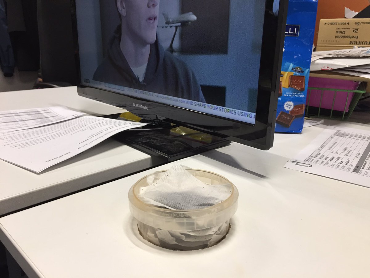 morningireland's tweet image. Ingenious use of that hole in the desk where the cables are supposed to come through #teabags #soupcontainer #breakfastcuppa