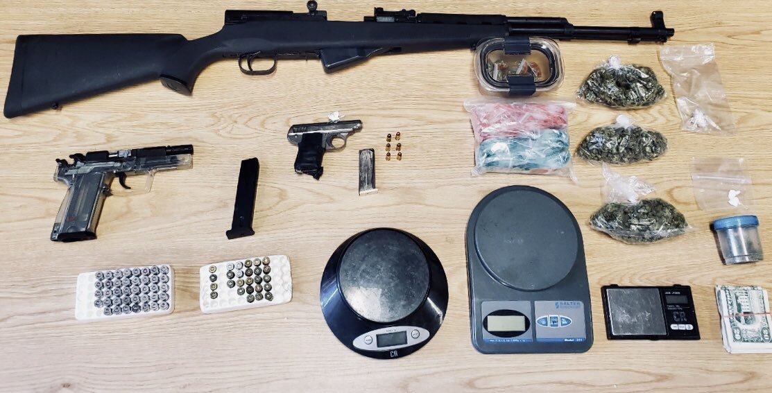 Guns and drugs on a table.