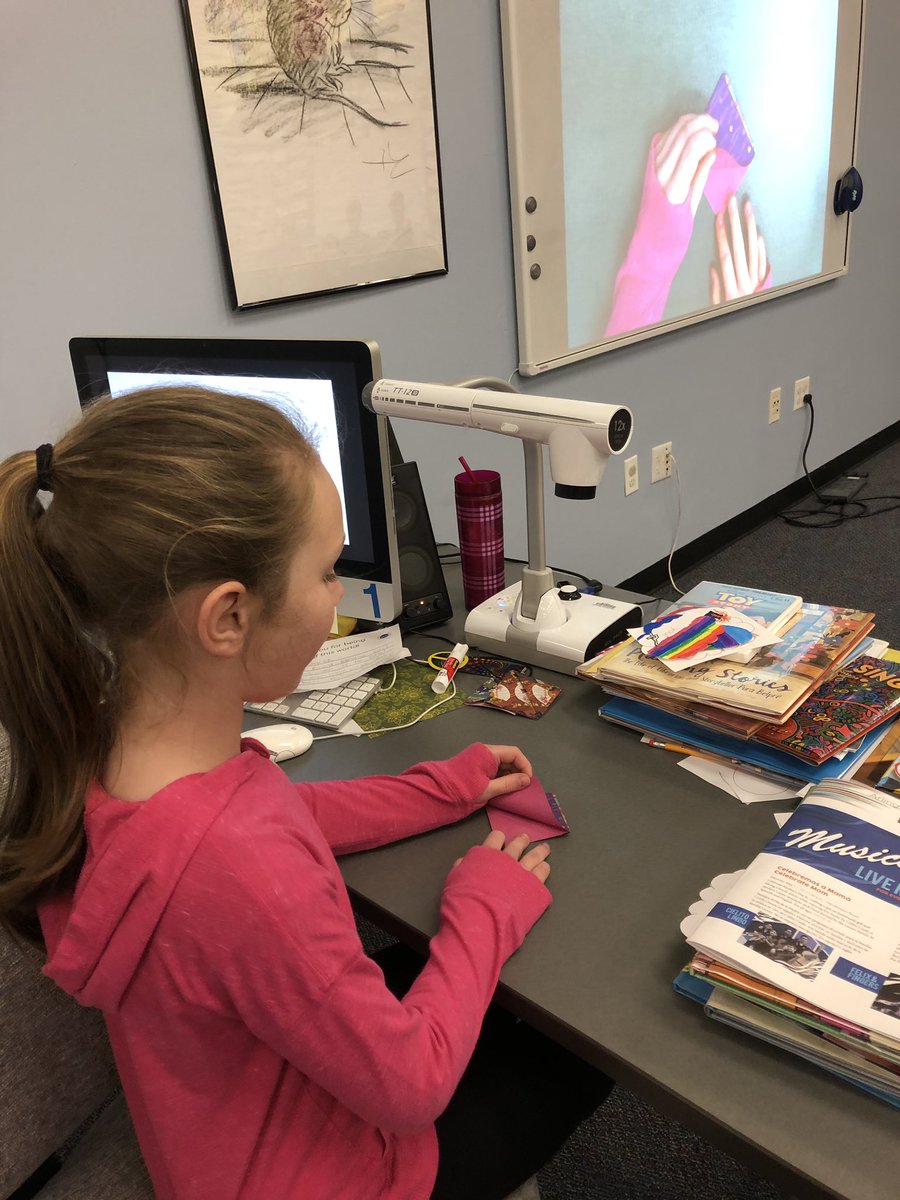 GailKomarek's tweet photo. J is teaching @martin3_m class how to fold corner bookmarks. Then creating #kindnessnotes to hide in books in the LMC and classroom. @WindsorWildcats @Windsor_PTA https://t.co/mOsJ6vAO9F