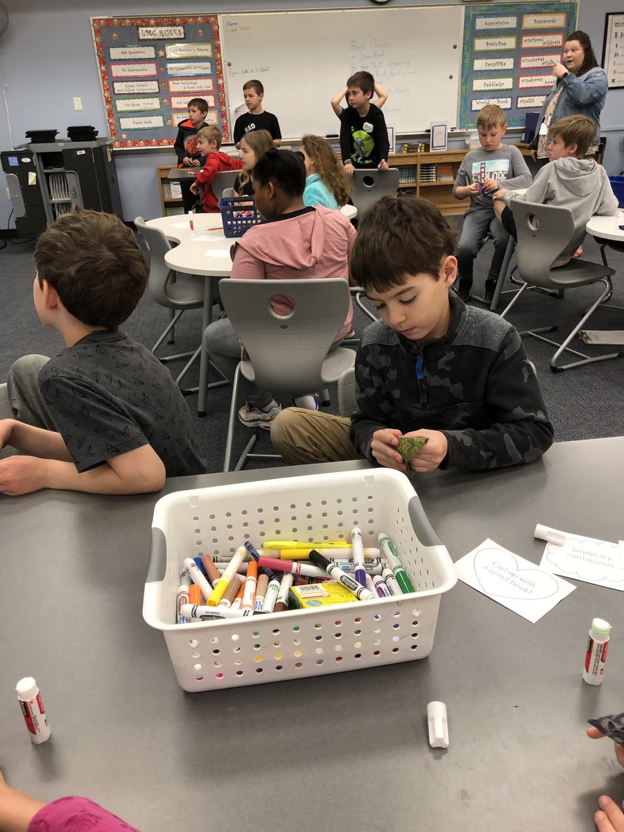 GailKomarek's tweet photo. J is teaching @martin3_m class how to fold corner bookmarks. Then creating #kindnessnotes to hide in books in the LMC and classroom. @WindsorWildcats @Windsor_PTA https://t.co/mOsJ6vAO9F