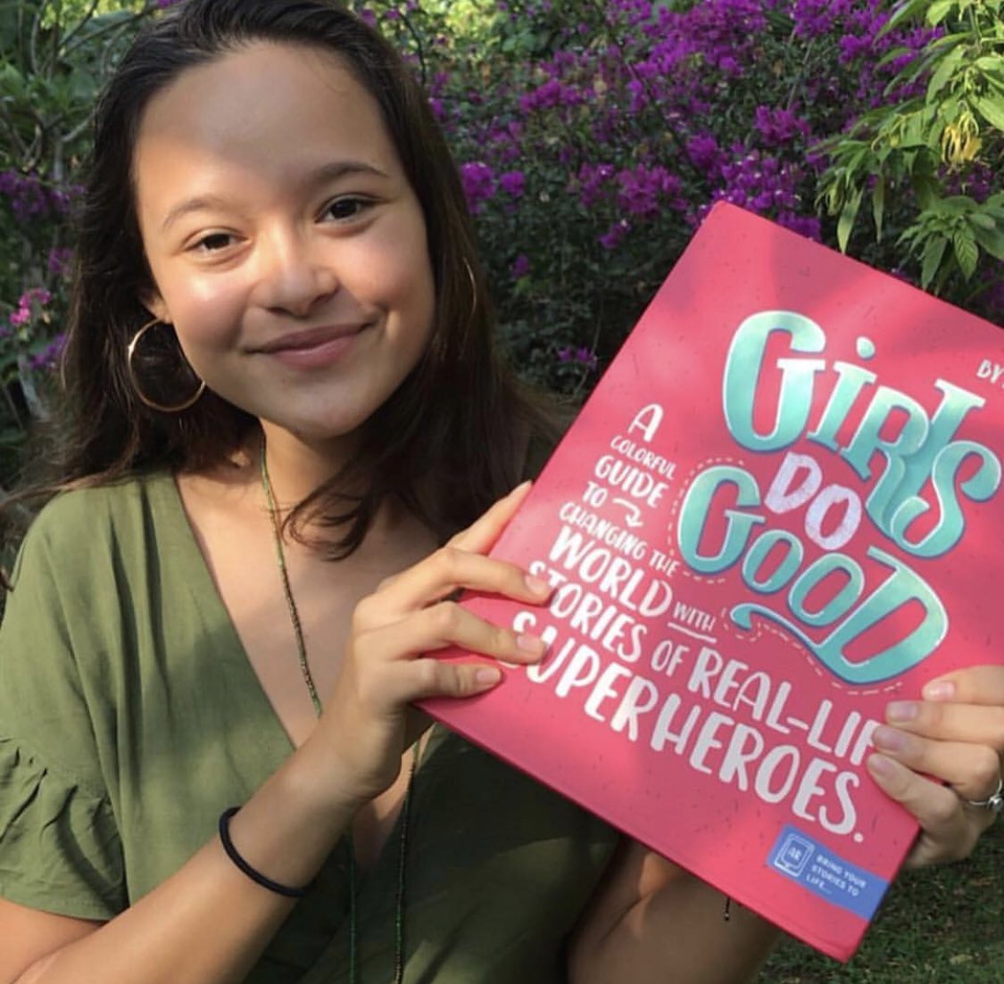 TDCPublishing's tweet photo. Melati Wijsen from @byebyeplasticbags with her copy of #GirlsDoGood. Melati is one of 11 real-life superheroes featured in the book. Through the book’s augmented reality features, Melati’s mission to clean the world’s beaches has been brought to life through gamified learning. https://t.co/5odjcLC20H