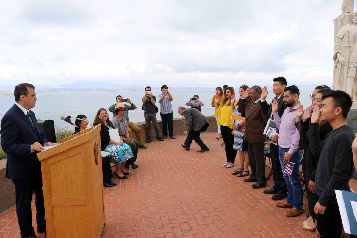USCIS's tweet photo. Director Cissna administered the Oath of Allegiance during a naturalization ceremony at the Cabrillo National Monument in San Diego, CA. During this picturesque ceremony, 10 people naturalized from 5 countries: China, Iraq, Philippines, and Vietnam.  #newUScitizen https://t.co/AvI6ZewqF0