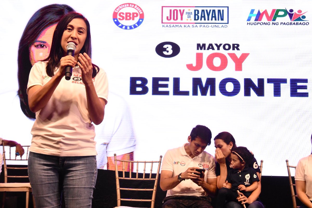 Quezon City mayoralty candidate Joy Belmonte speaks before the crowd of city’s first district, where the Miting de Avance of Serbisyo ng Bayan Party (SBP) was held. At the background is her running mate Gian Sotto with his wife and daughter. May 11, 2019.