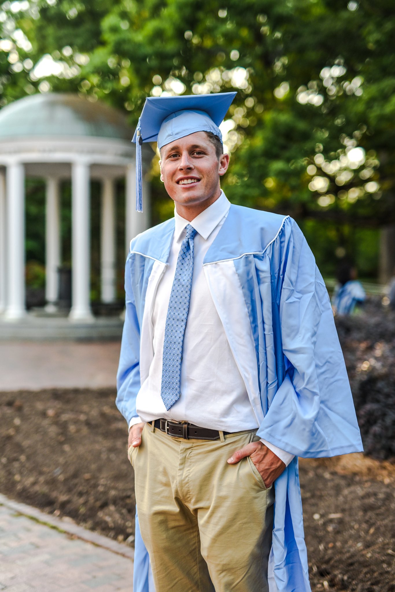 Male high school student in graduation outfit on school campus Stock Photo  - Alamy