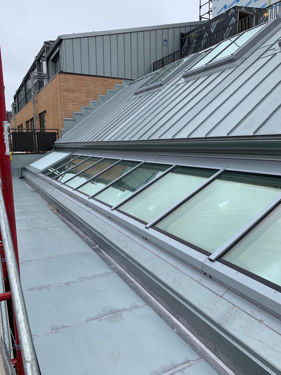 Meanwhile up on the roof ⁦<a href="/FriendsSeminary/">Friends Seminary</a>⁩ sky lights for the window well that separates the facade of restored townhouses &amp;the new building behind.A nice view of how the two buildings meet at upper level.