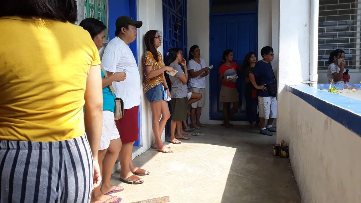 manila_today's tweet photo. Voters line up outside as they wait for their turn to vote in Barangay San Carlos, Binangonan, Rizal. Photo by Gabriela Baron #PHelection2019 https://t.co/uPp4bwPw7s
