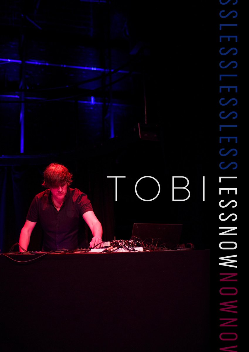 Poster with focused DJ Tobi Lessnow on stage doing his thing in red and blue lighting