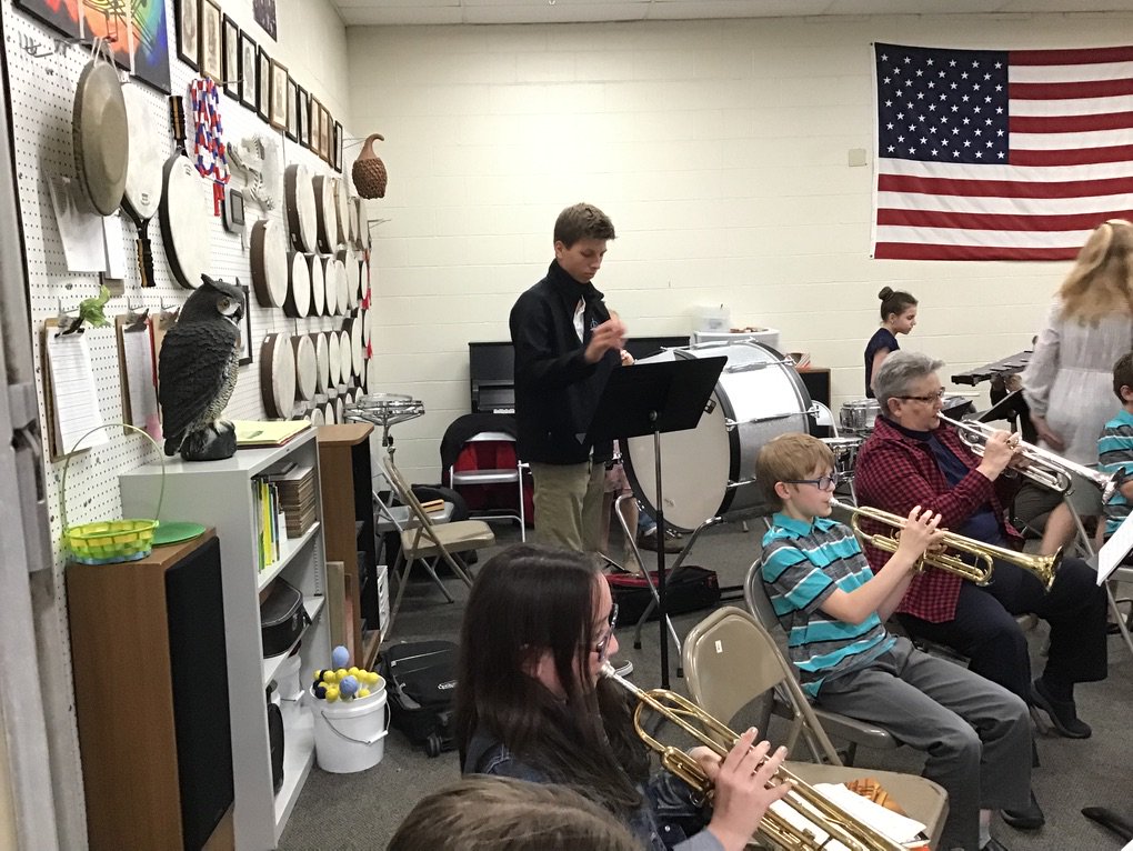 Spring concert at Grace Abbott featuring several siblings, parents, and grandparents performing with their fifth grader.