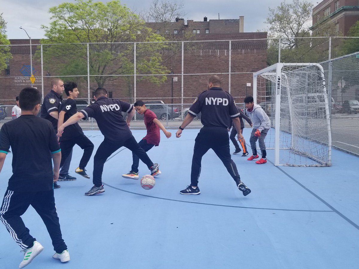 Cops and kids playing soccer.