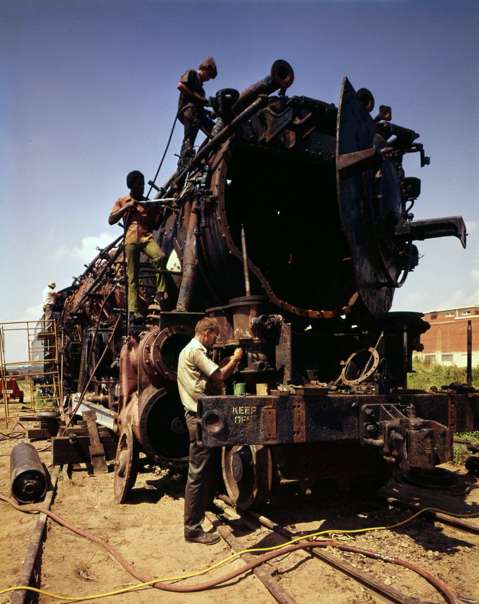 TexasHighways's tweet photo. Laborers in Fort Worth work to restore a locomotive that will pull the American Freedom Train across Texas as part of the country's bicentennial celebration. Photo from 1975 by Jack Lewis. #ThrowbackThursday https://t.co/7Cn7Ie8t5j