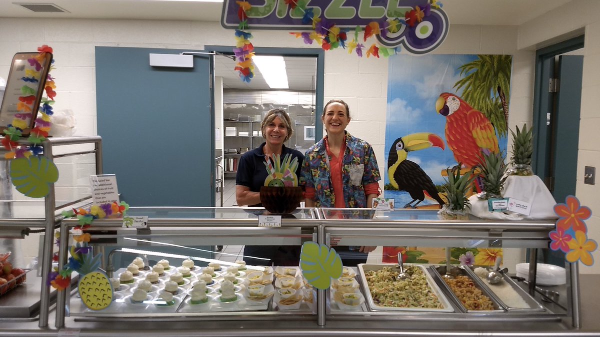 GLPS_rightnow's tweet image. Even lunch is for learning! Alexa Ross -- an MSU intern in the colorful shirt next to GLPS's Carol Jegla -- created a special Hawaiian themed lunch at Hayes: Hawaiian sweet &amp;amp; sour chicken, Hawaiian sticky rice, mango pineapple fruit salsa, tiki time coleslaw, &amp;amp; coconut cupcakes.