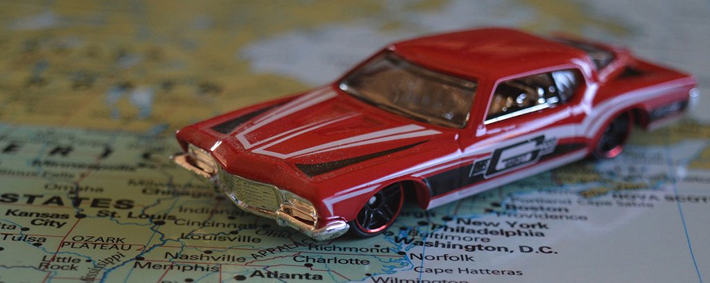 a toy car on top of a road map